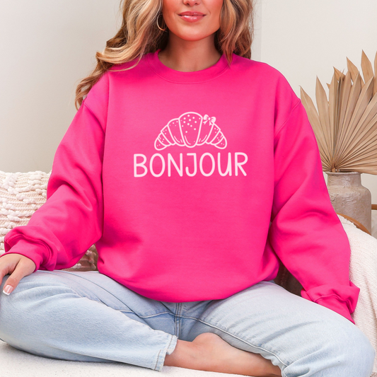 Bonjour Croissant Sweatshirt featuring a cute croissant design with a bow, inspired by French cafe culture.