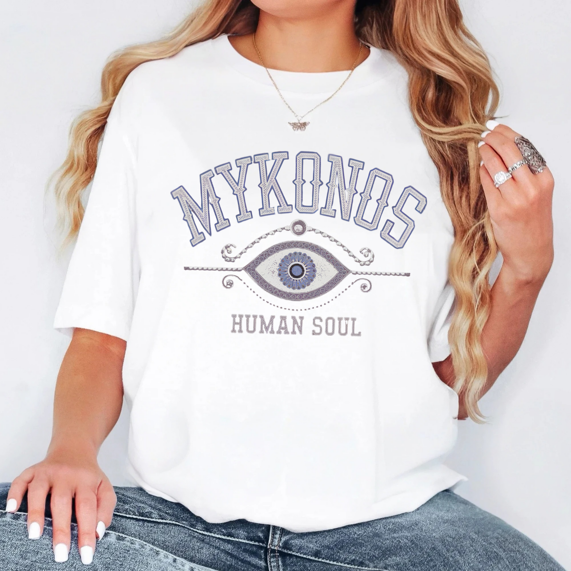 Mykonos Evil Eye T-Shirt featuring a minimalist Greek-inspired protection symbol, perfect for travel and spiritual wear.