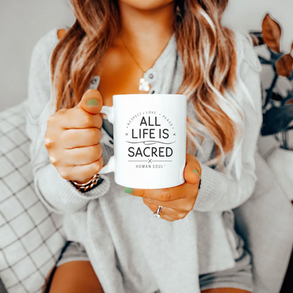 11oz ceramic mug featuring the quote 'All Life Is Sacred' in a minimalist, spiritual design.