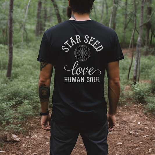 A man standing and admiring nature wearing the Star Seed Love Geometric Men's T-shirt